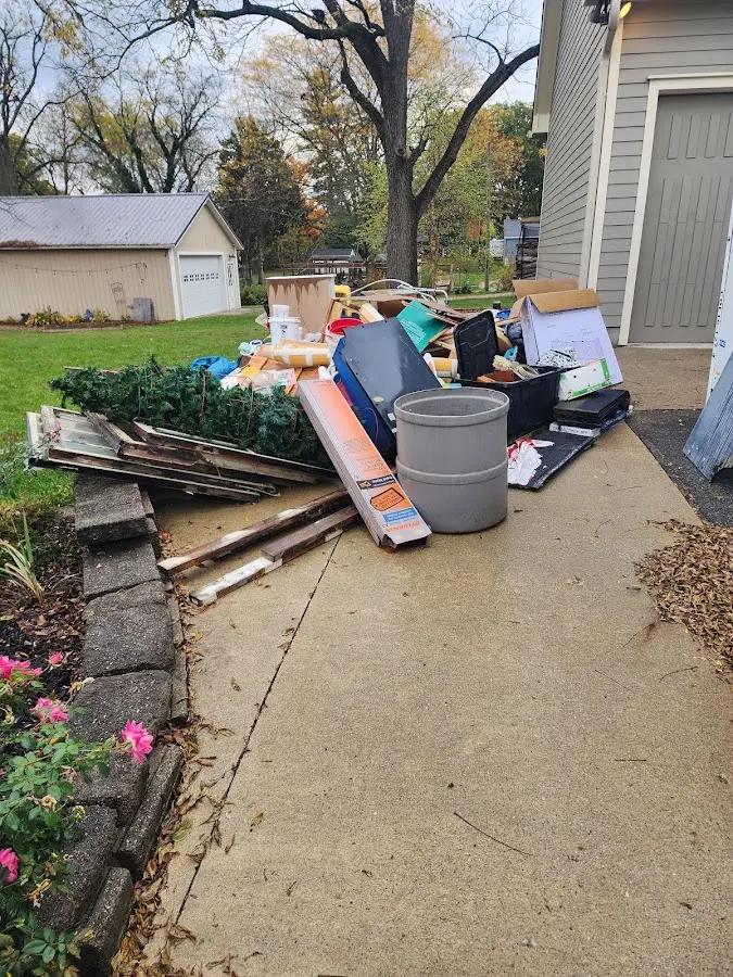 Dumpster being loaded with debris for Roofing Dumpster Rental in Decorah